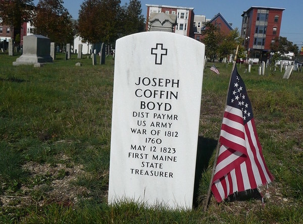Joseph Coffin Boyd's white marble military grave stone with a small US flag stuck in the ground next to it