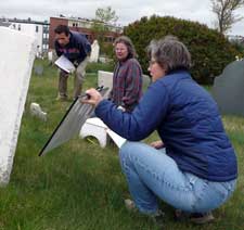 Art, April and Martha read a marble stone with a mirror