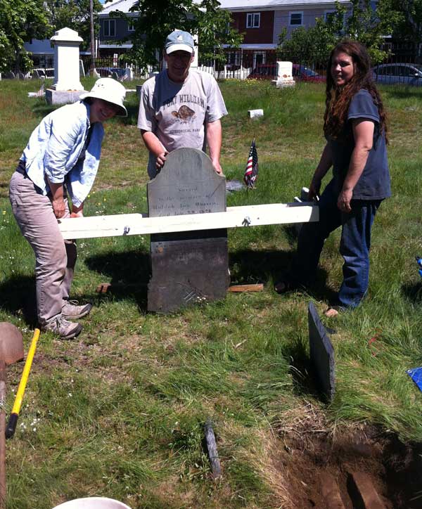 Preparing to move a gravestone into place