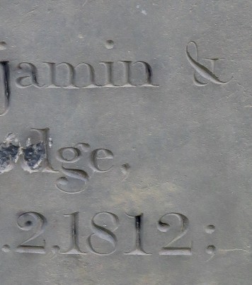 detail from an inscription carved into a slate stone