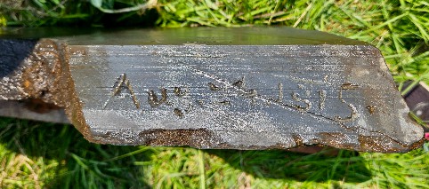 slate fragment photographed from the unfinished edge and carved with Aug. 24, 1815