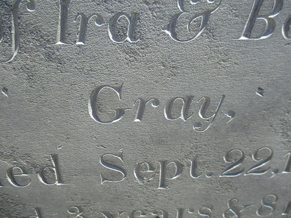 detail from a slate gravestone carved with the word Gray
