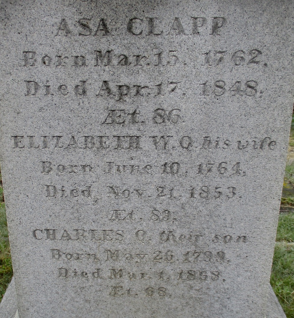 detail of an old granite grave monument for Asa Clapp, Elizabeth, and Charles