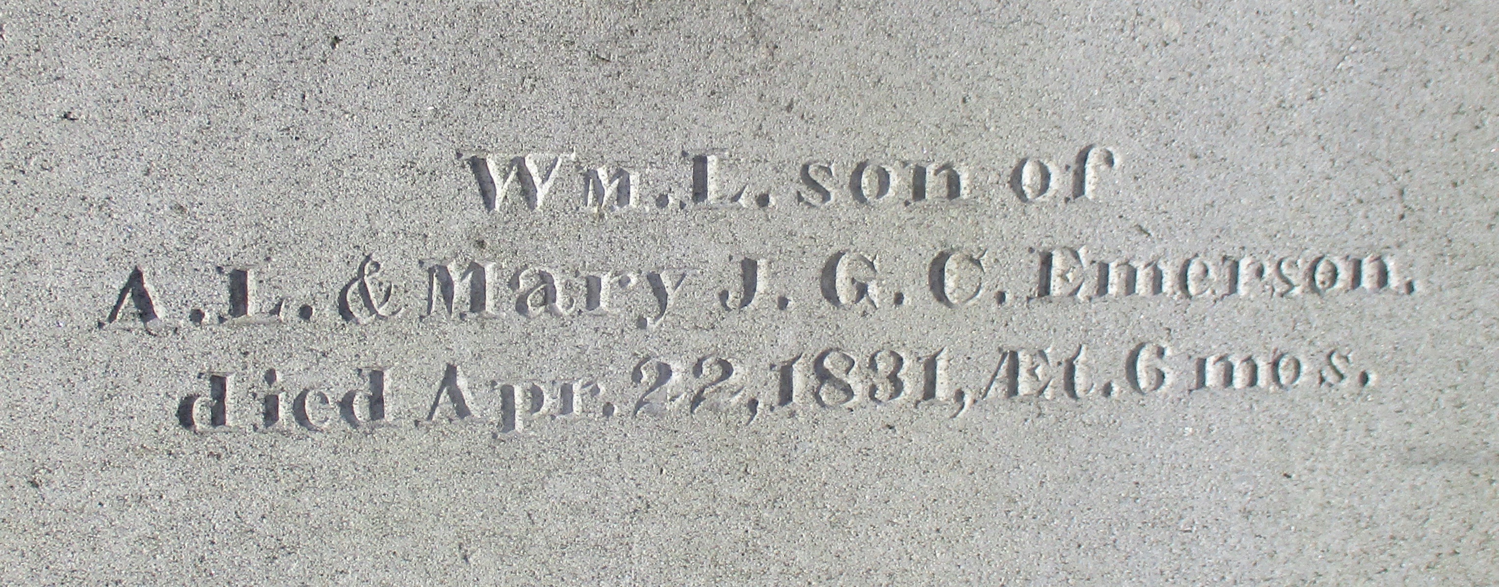 detail of an old granite grave monument for William Emerson